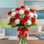 Flores claveles blancos y rojos para condolencias en arreglo floral de luto